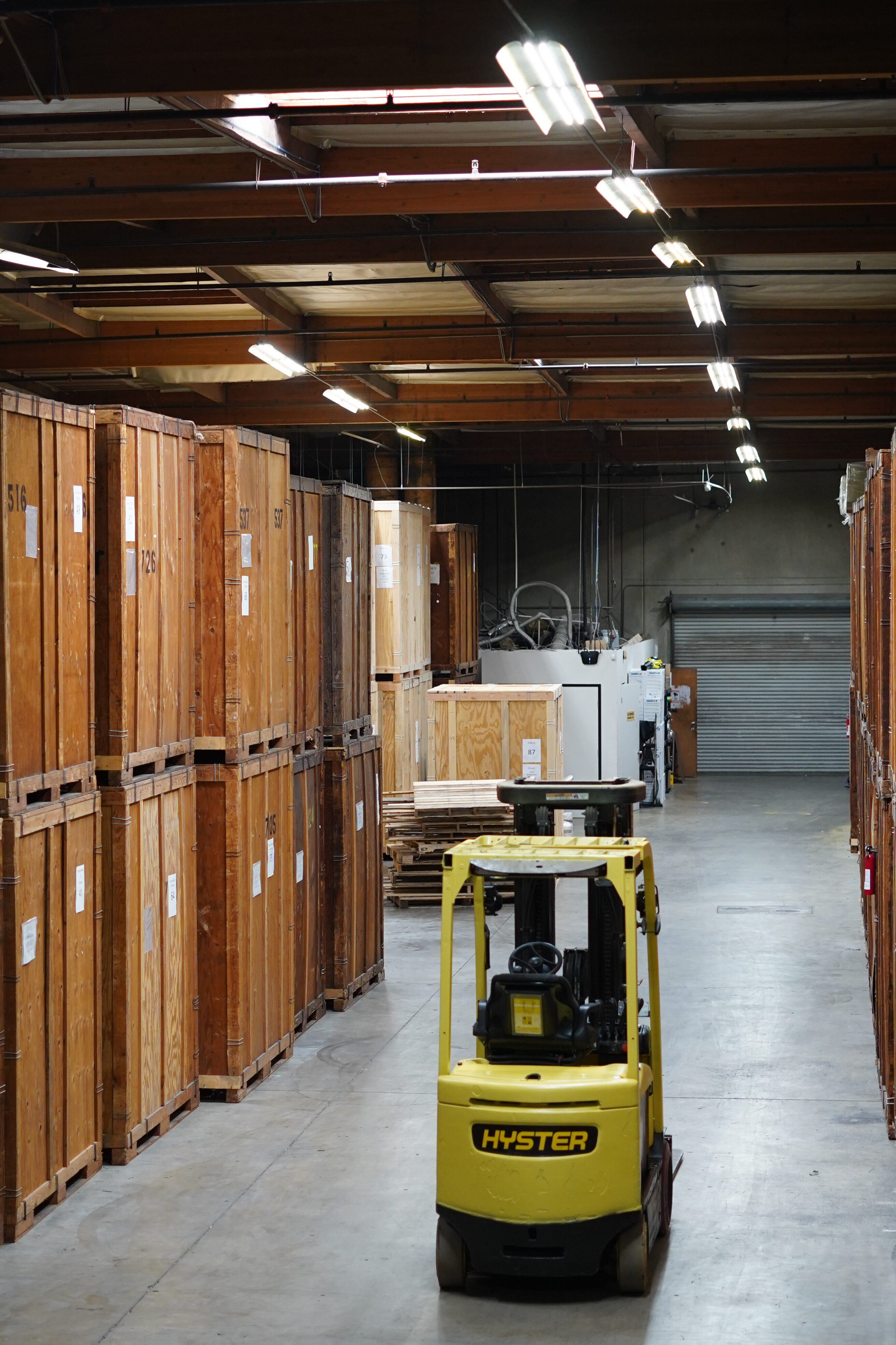 Wooden moving vaults and forklift equipment inside the Vector warehouse