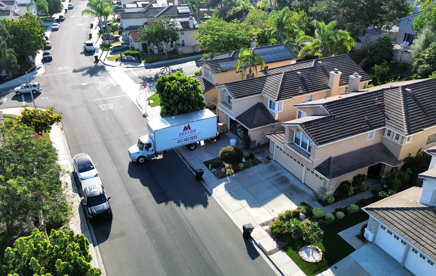 Vector moving truck at a landscaped single-family residence