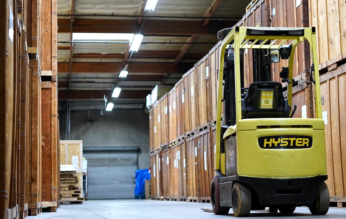 Forklift and wooden storage vaults inside the Vector warehouse