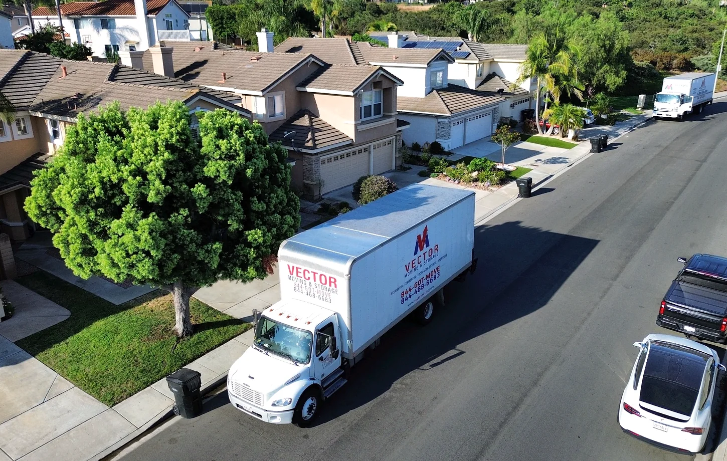 Vector moving trucks positioned on a residential street with different parking distances