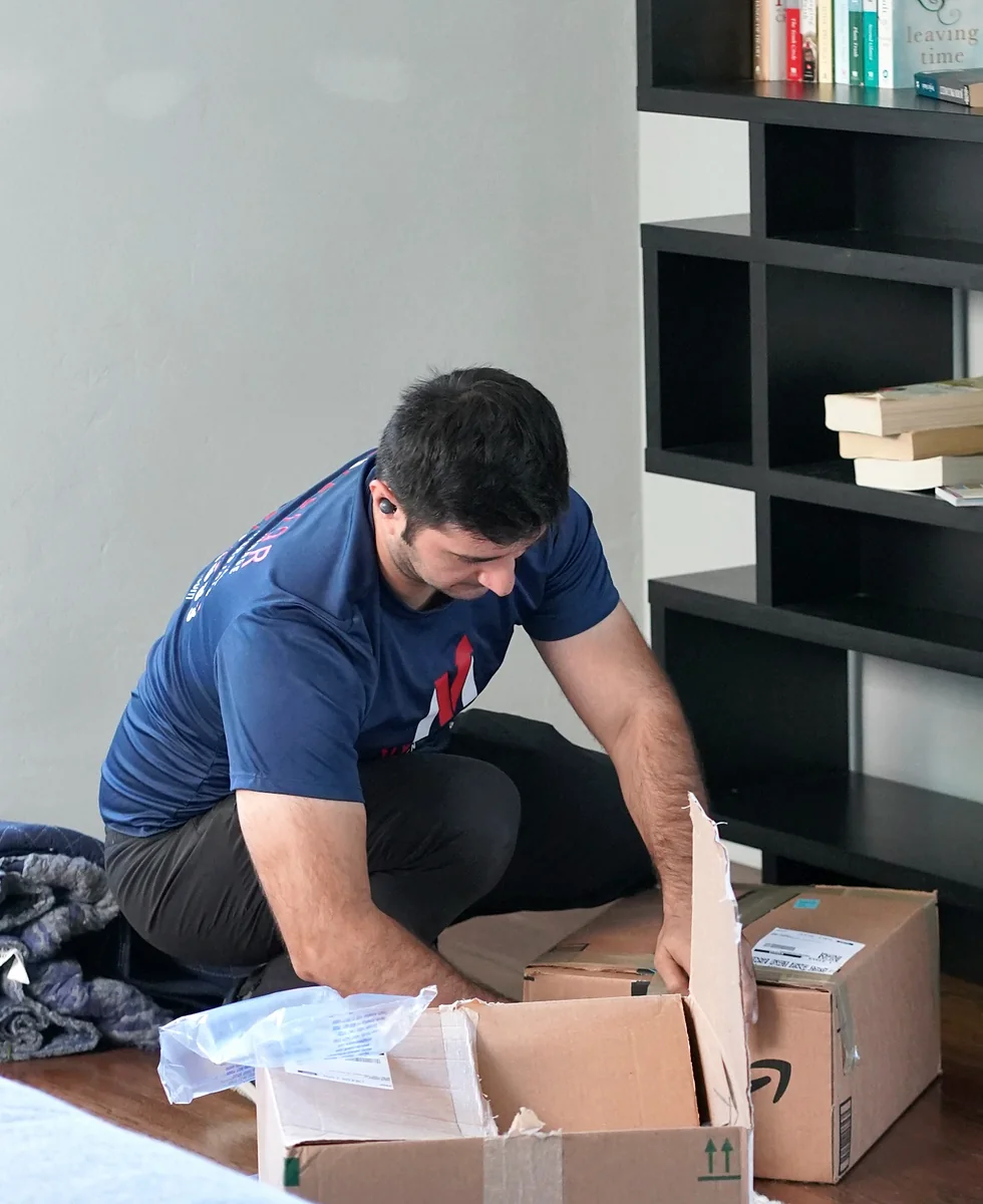 Vector mover packing household belongings inside a home