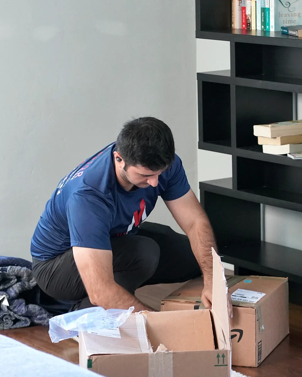 Vector mover packing household belongings inside a home