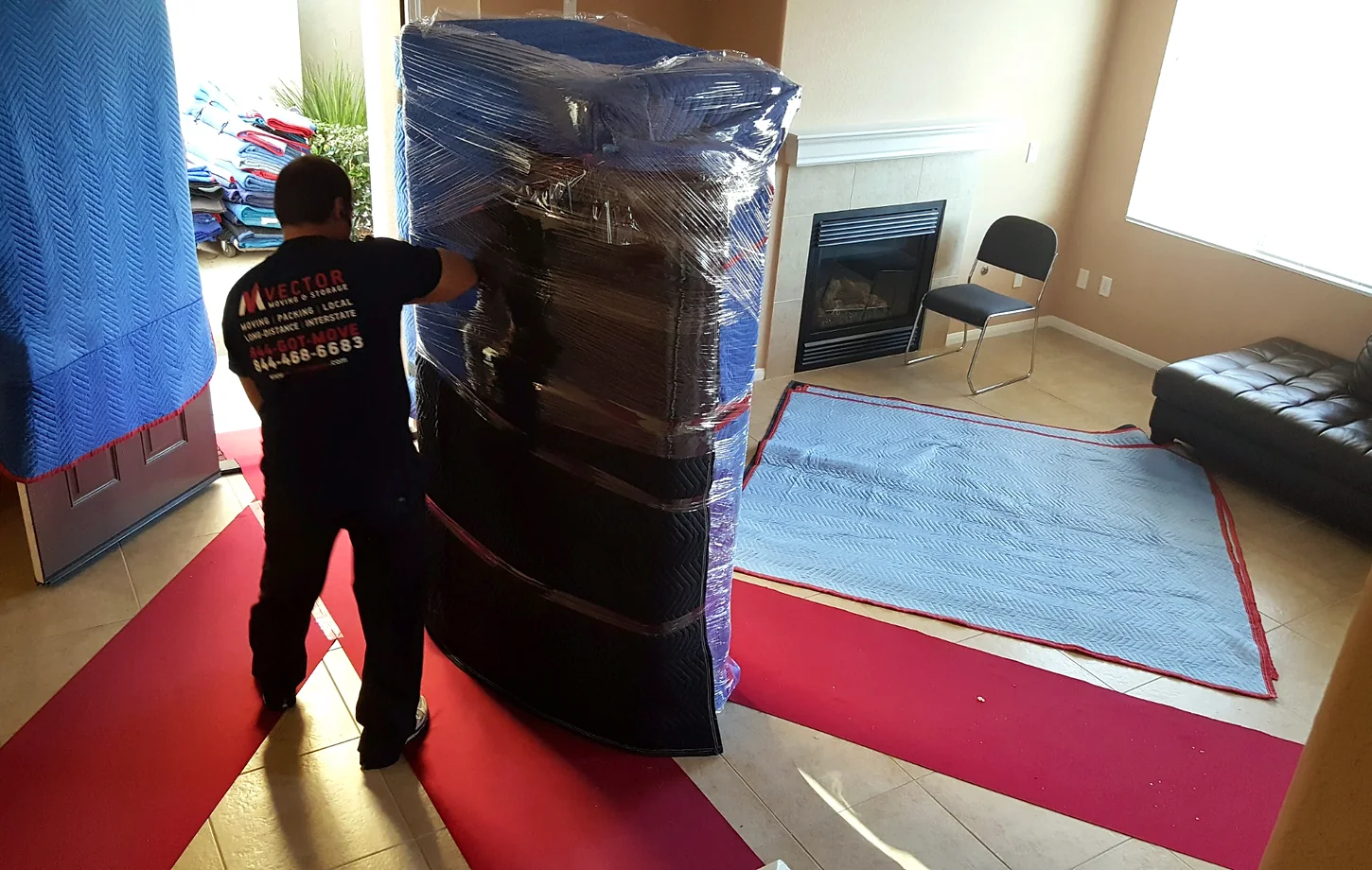 Vector mover handling wrapped furniture over floor and doorway protection