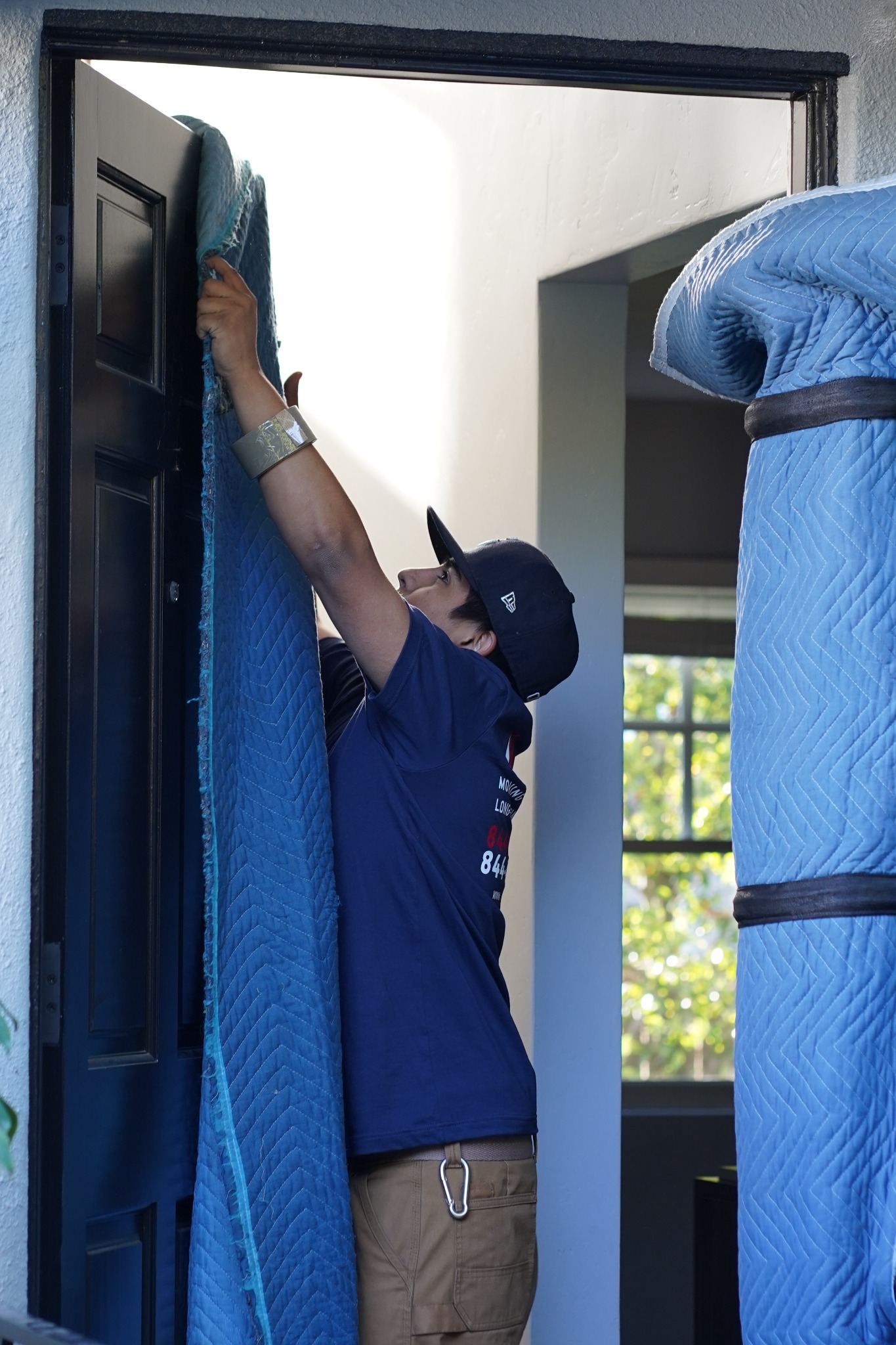 Vector mover protecting a doorway while preparing a San Diego home for moving