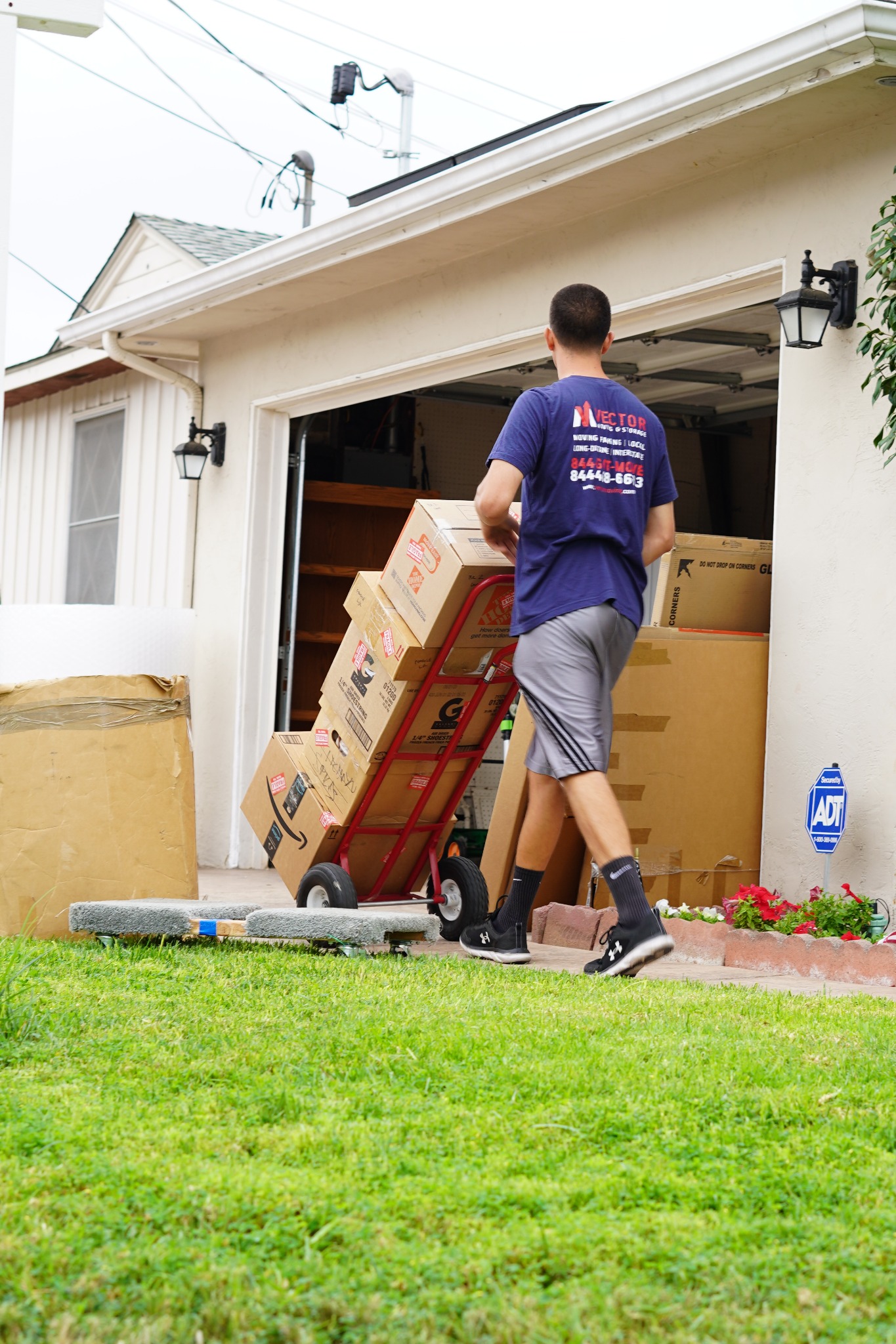 Vector mover transporting reusable cardboard boxes from a San Diego home