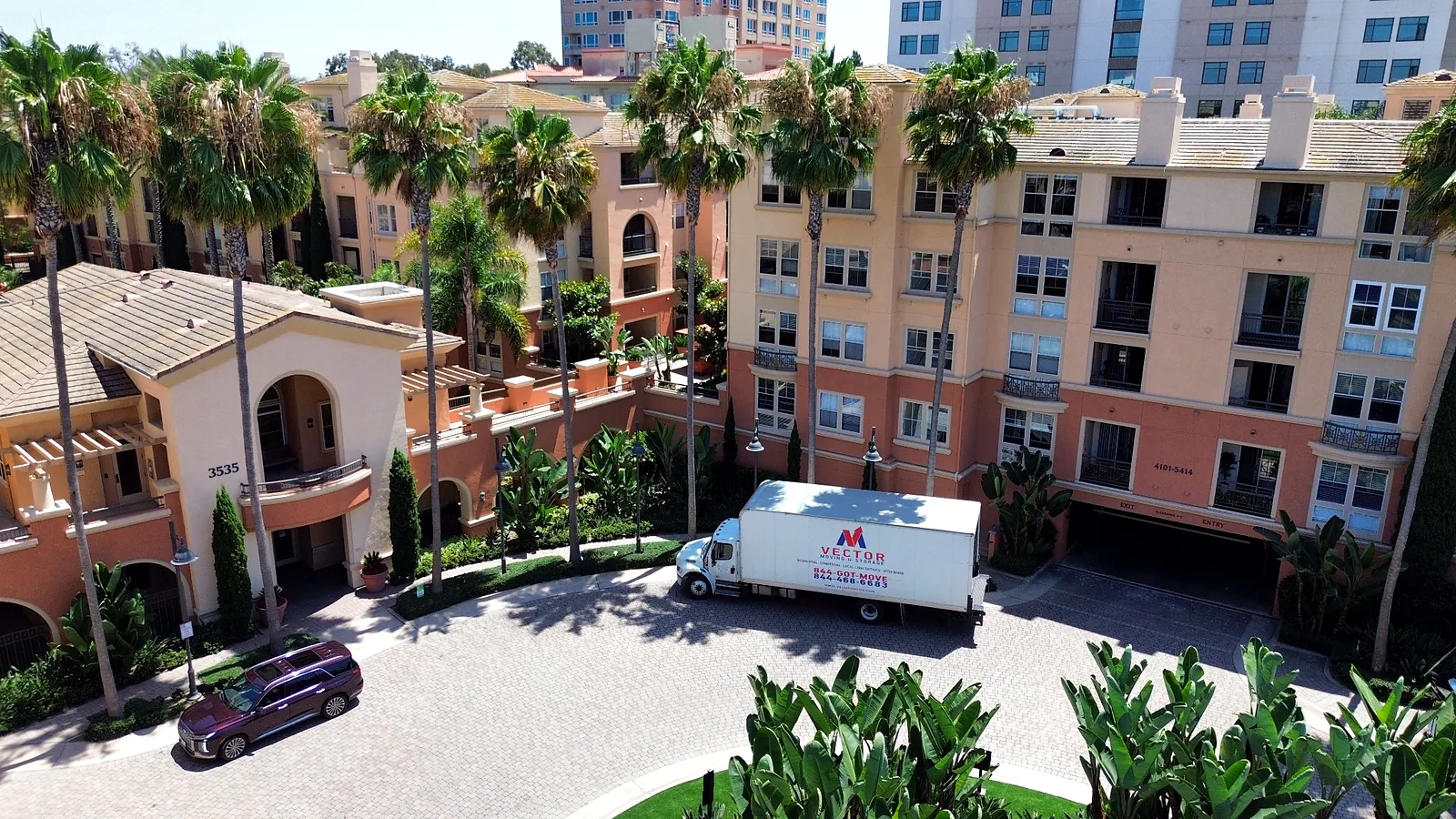 Vector moving truck positioned inside a condominium community in San Diego