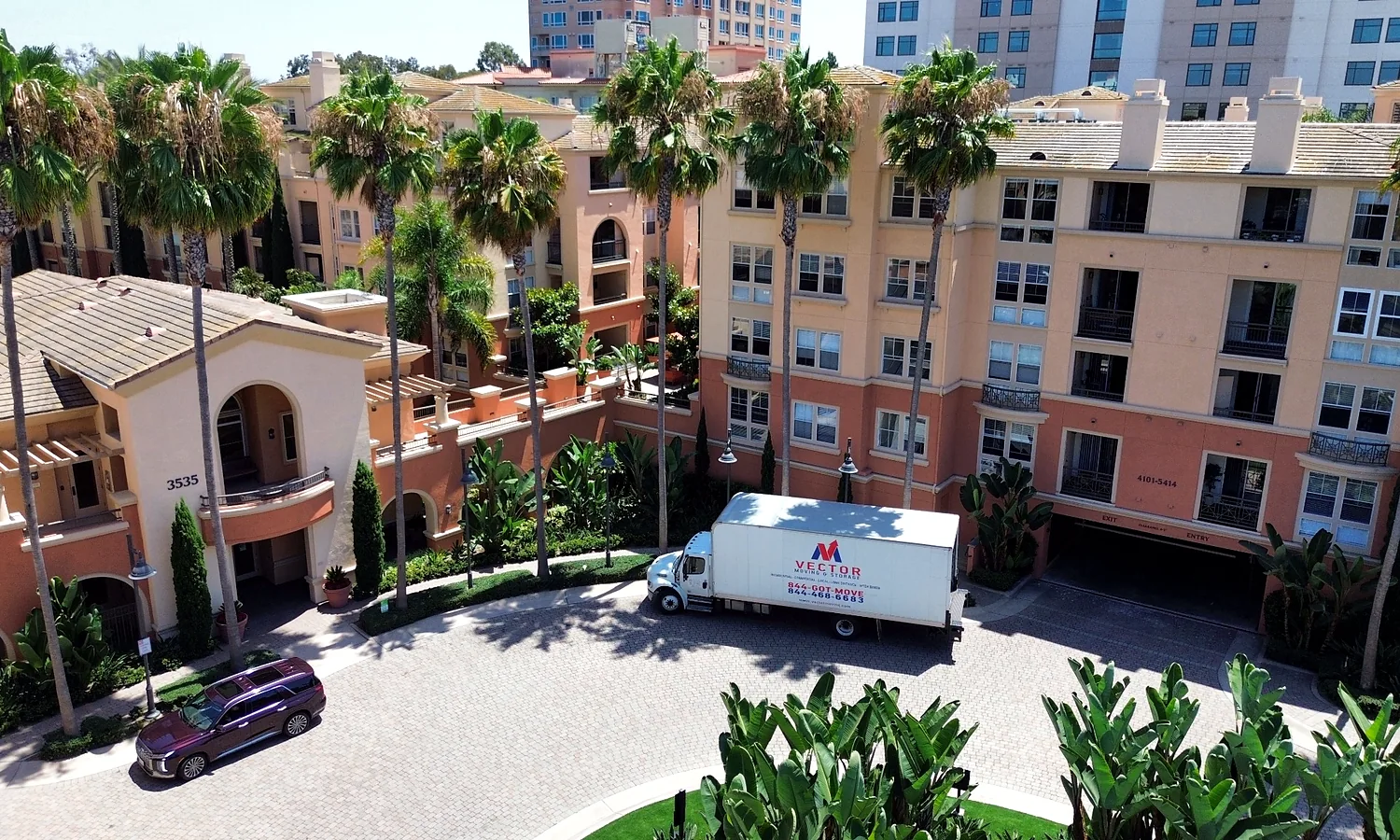 Vector moving truck positioned at a multi-unit residential property