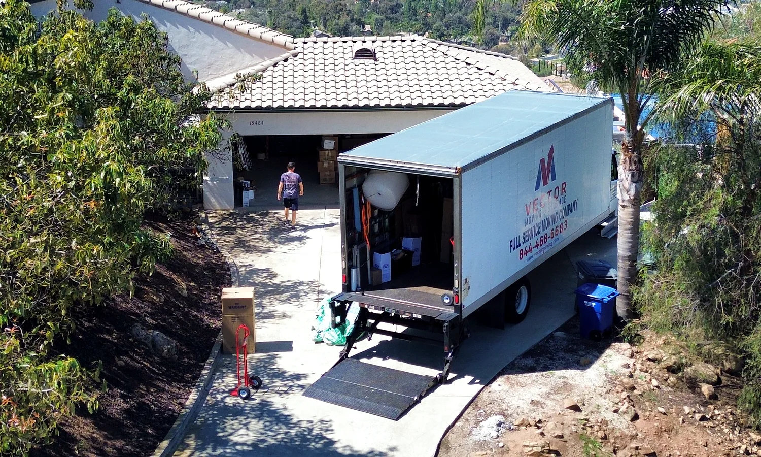 Vector moving truck positioned on a residential driveway for pickup