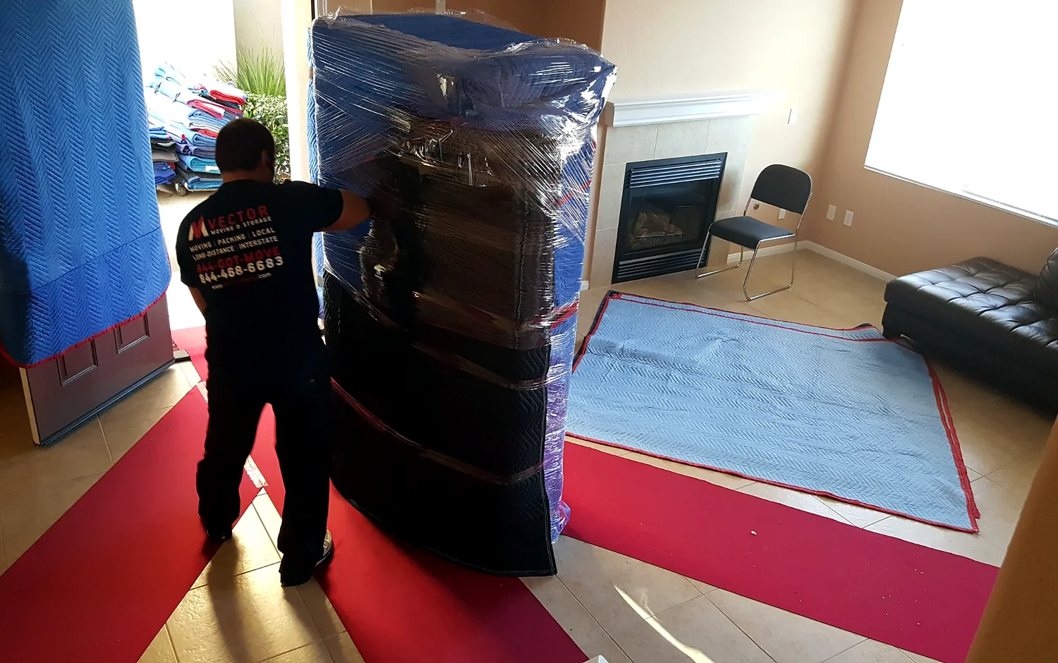 Wrapped furniture moving across protected floors inside a home