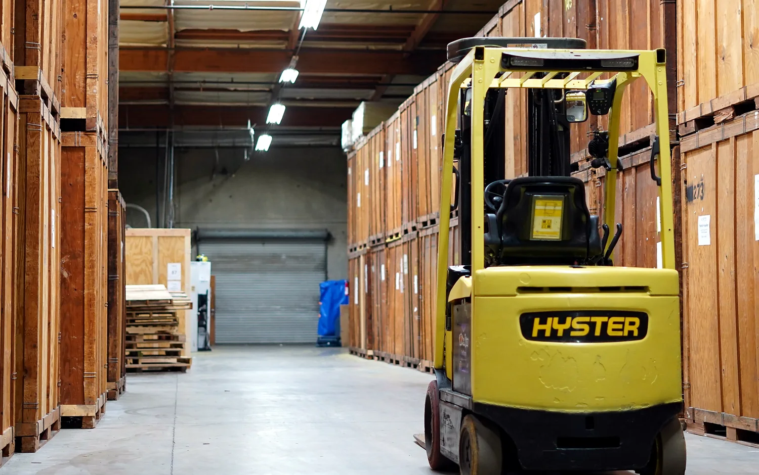 Forklift and wooden moving vaults inside the Vector warehouse