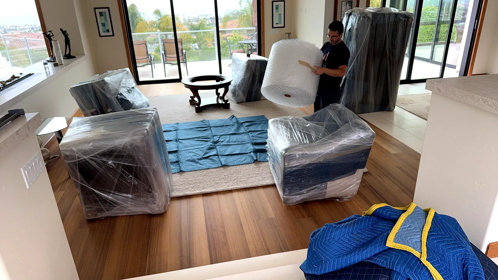 Several household furniture pieces wrapped and organized before moving or storage