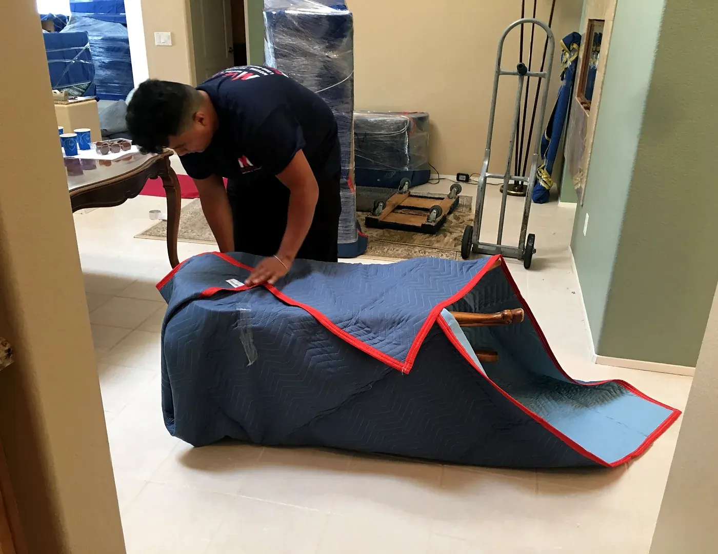 Vector mover securing a moving blanket around household furniture