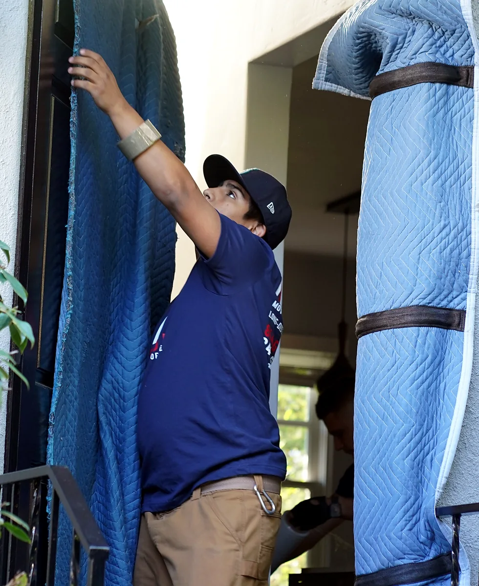 Vector mover installing padded protection around a residential doorway