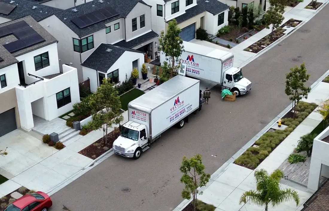 Two Vector moving trucks positioned for a residential relocation