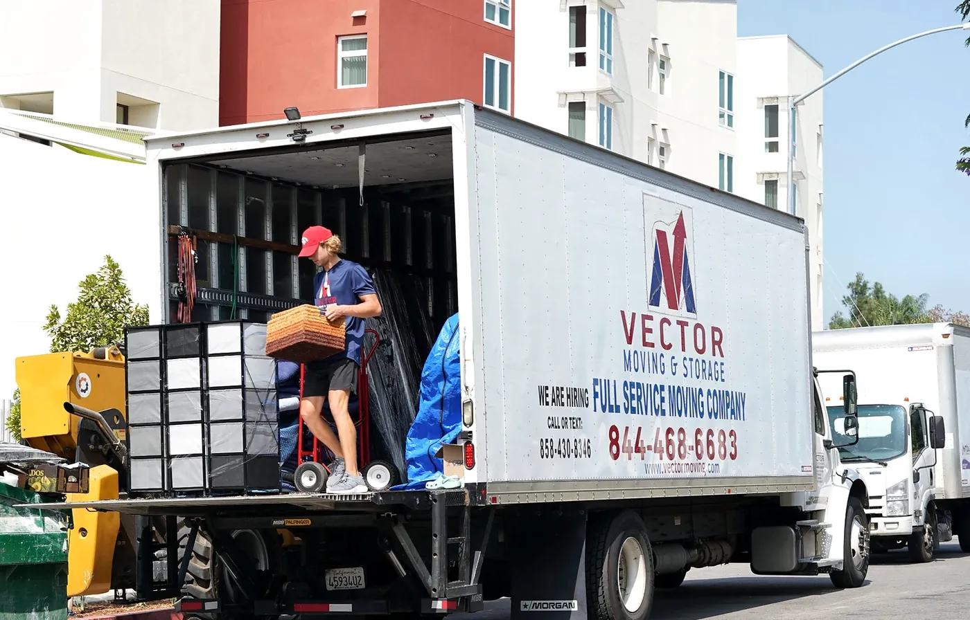 Vector commercial mover handling boxed contents at a branded truck