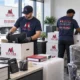 Vector-branded movers packing monitors and office equipment