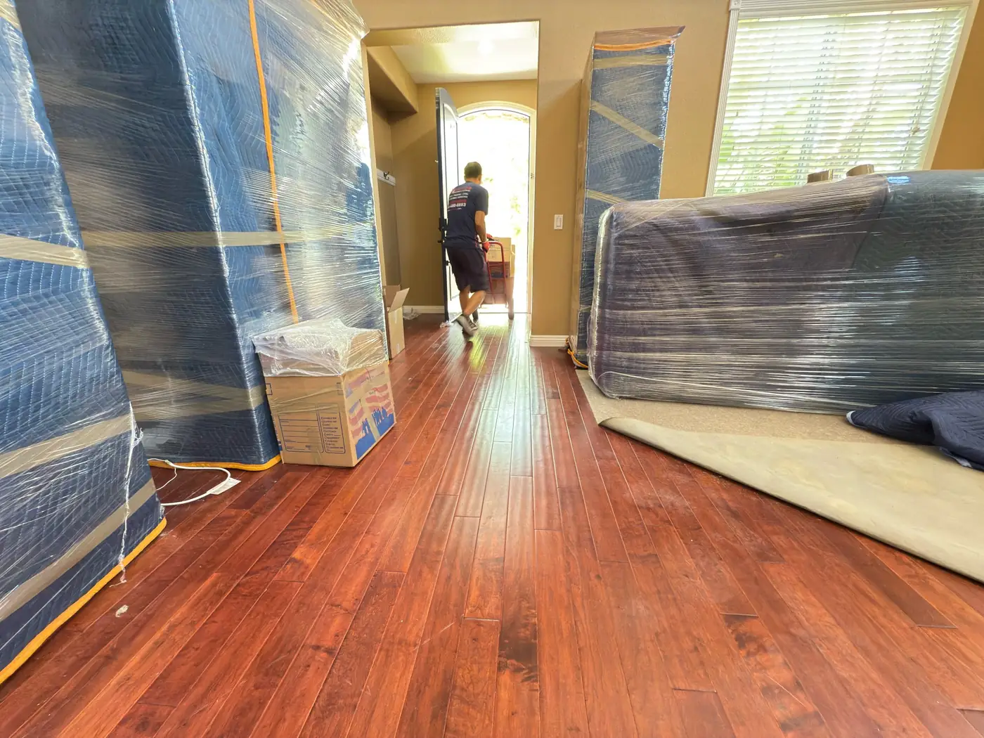 Wrapped furniture and protected floors prepared for a Vector move