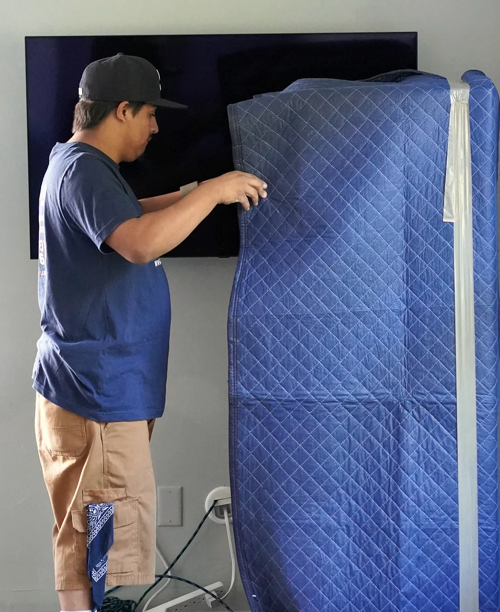 Vector mover wrapping furniture with professional moving blankets
