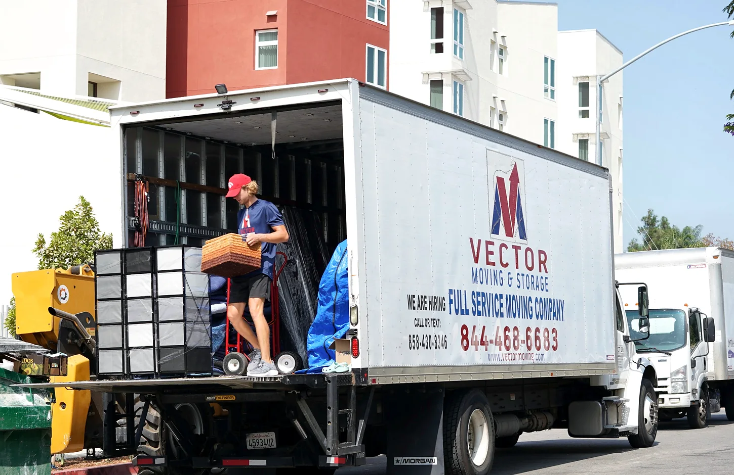 Vector moving truck being loaded for long-distance transportation