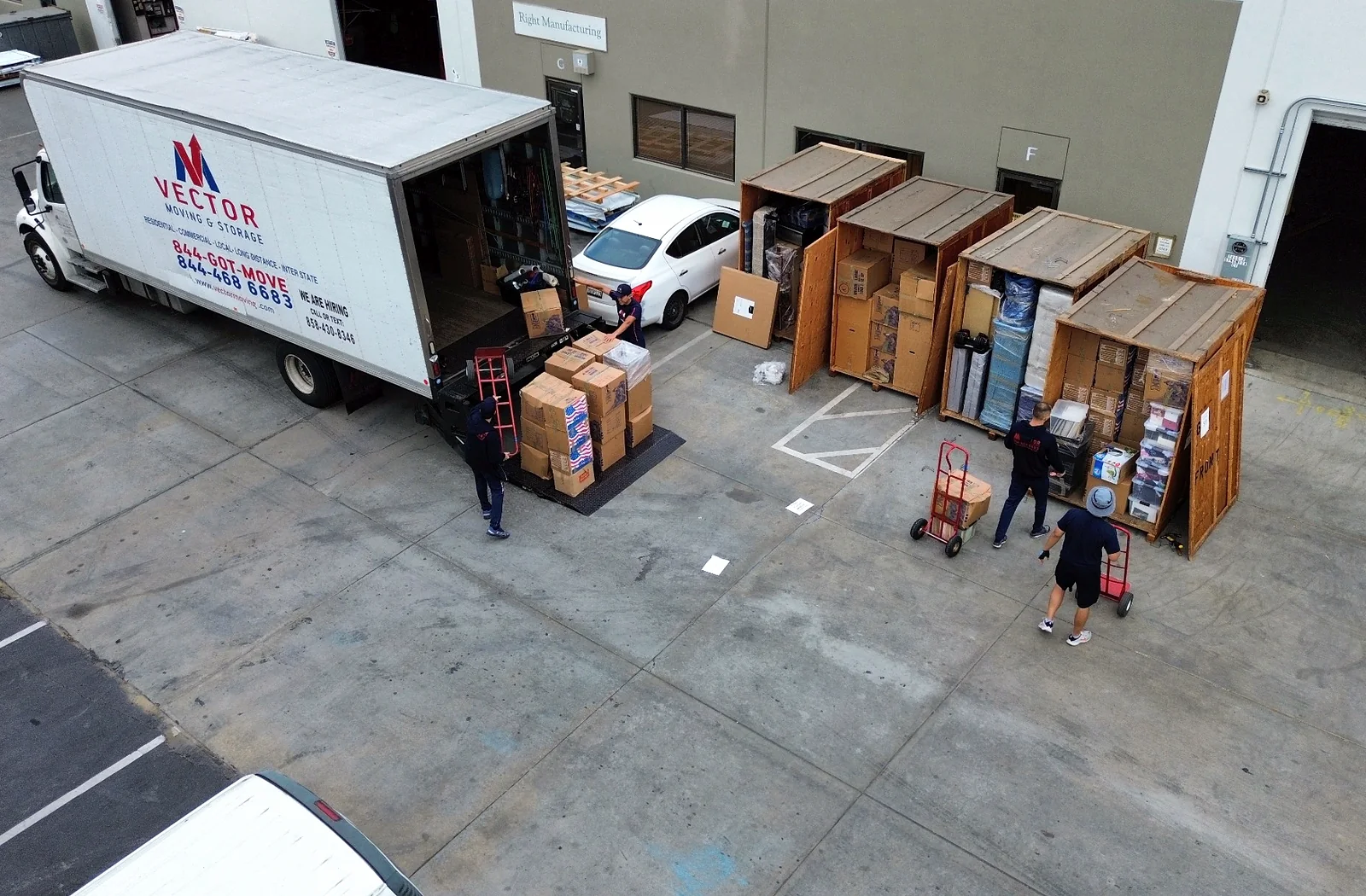 Vector Moving and Storage truck loading wooden storage vaults in San Diego