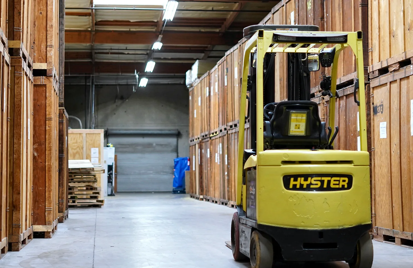 Forklift and wooden storage vaults inside the Vector warehouse