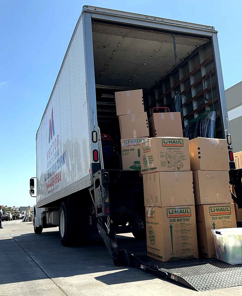 Vector moving truck loaded with organized household boxes