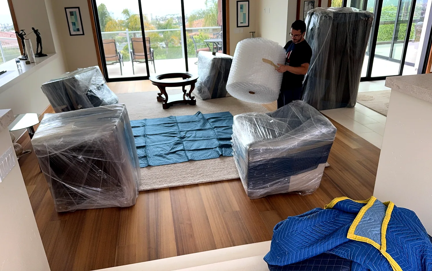 Protected furniture arranged inside a smaller residence before final placement