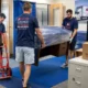Vector commercial movers loading office furniture and labeled boxes