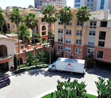 Vector Moving and Storage truck outside a multi-building residential community