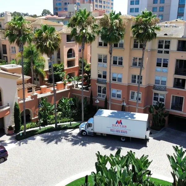 Vector Moving and Storage truck outside a multi-building residential community