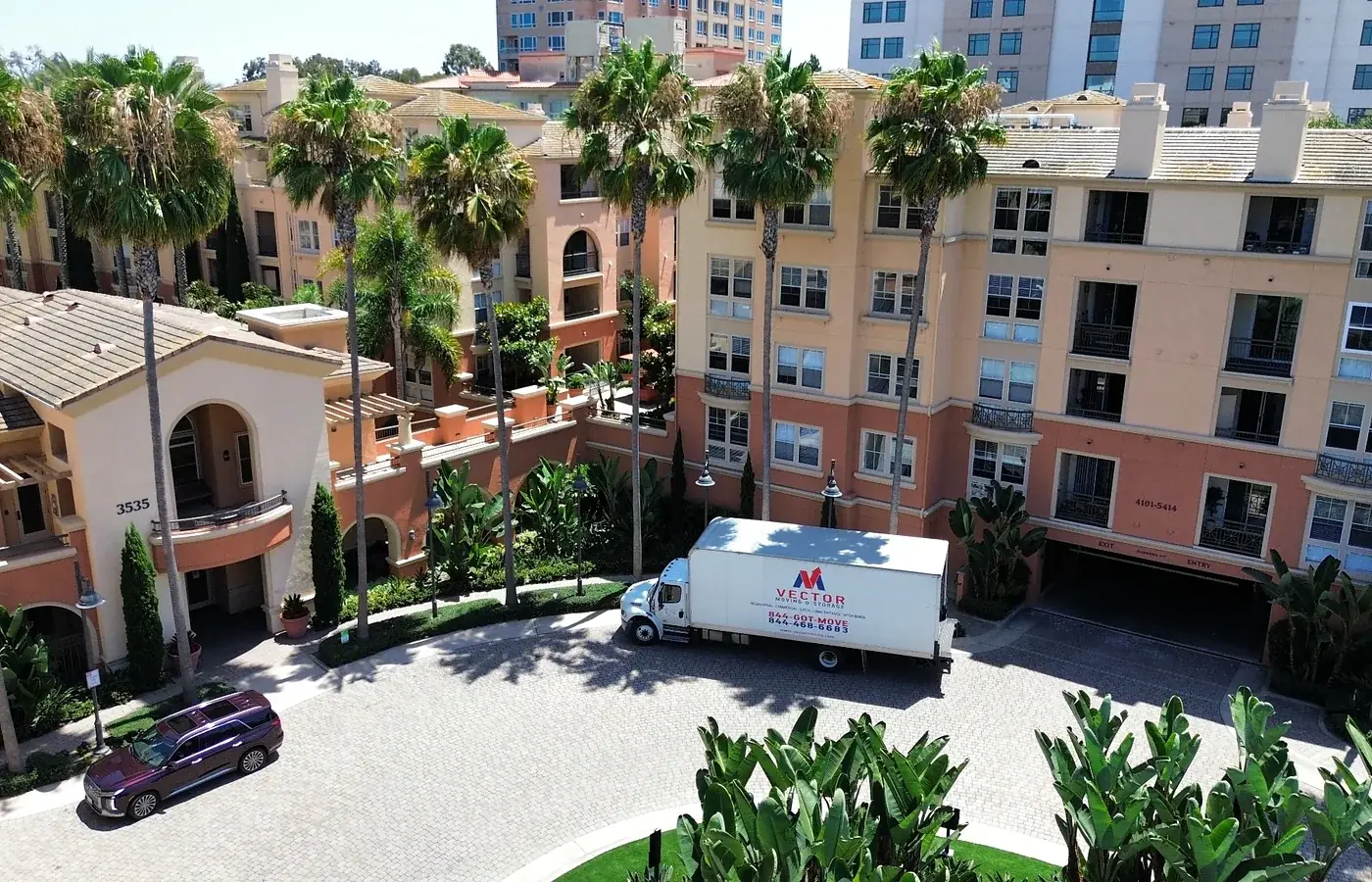 Vector Moving and Storage truck outside a multi-building residential community