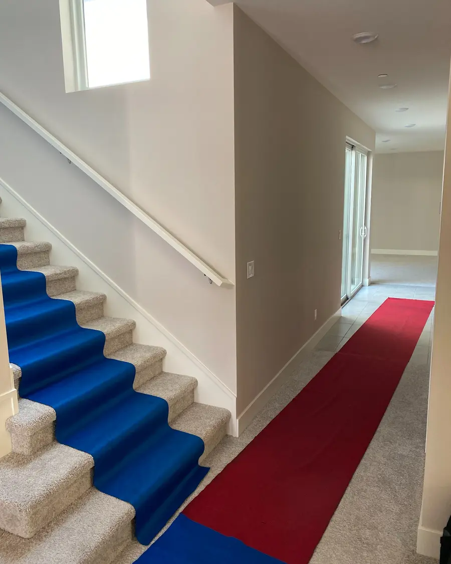 Protective runners covering a home hallway and stairs