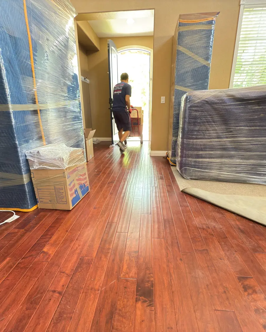 Household furniture protected with moving blankets and stretch wrap for interstate transport