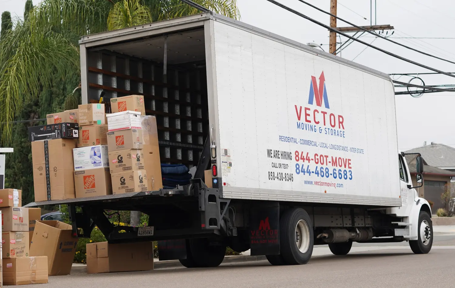 Moving boxes on the liftgate of a Vector Moving and Storage truck