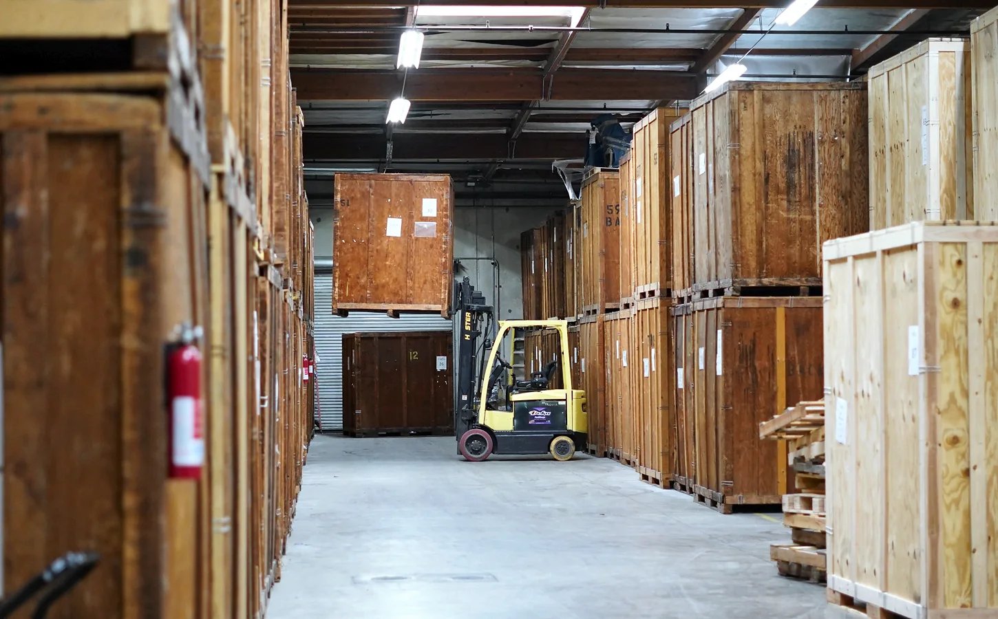Wooden storage vaults and a forklift inside the Vector warehouse