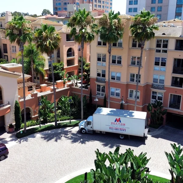 Vector Moving and Storage truck positioned at a multi-unit residential property