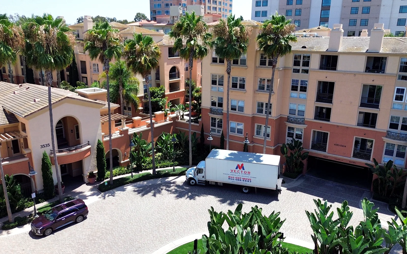 Vector Moving and Storage truck positioned at a multi-unit residential property
