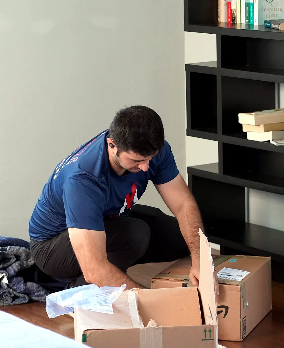 Vector mover packing household belongings inside a home