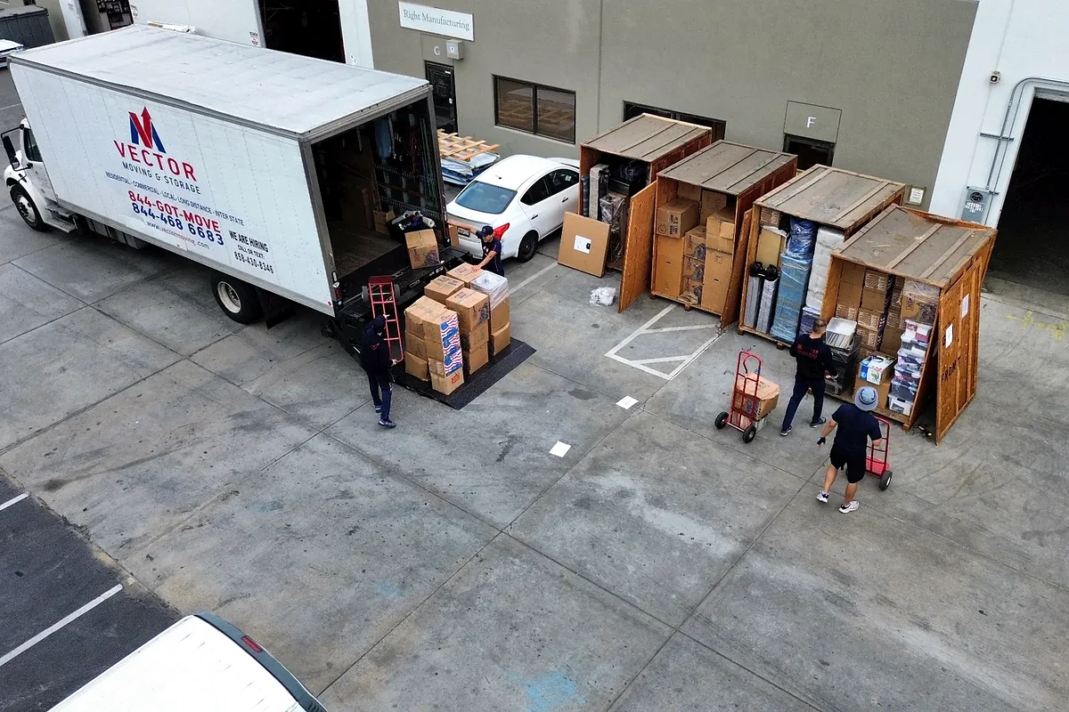 Vector truck and wooden storage vaults at a warehouse loading area