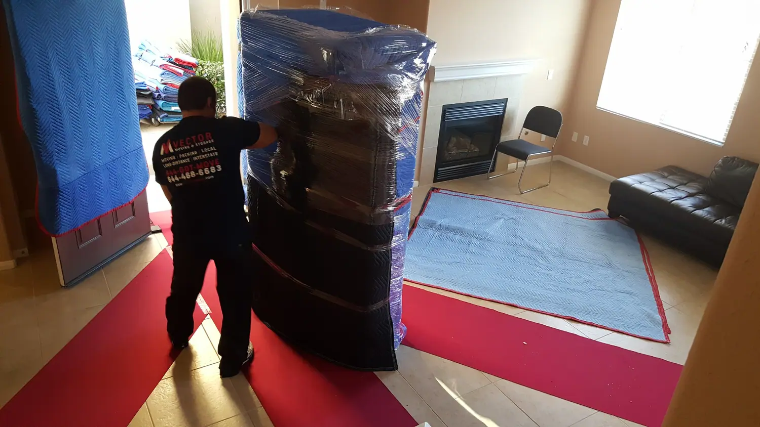 Household furniture protected with blankets and stretch wrap before loading