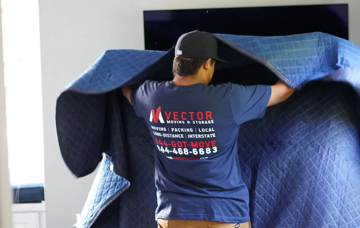 Vector mover protecting household furniture with a quilted moving blanket