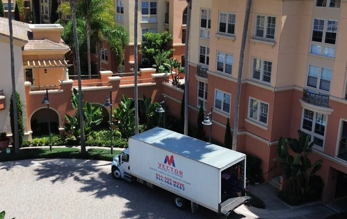 Vector moving truck positioned in a multi-unit residential courtyard
