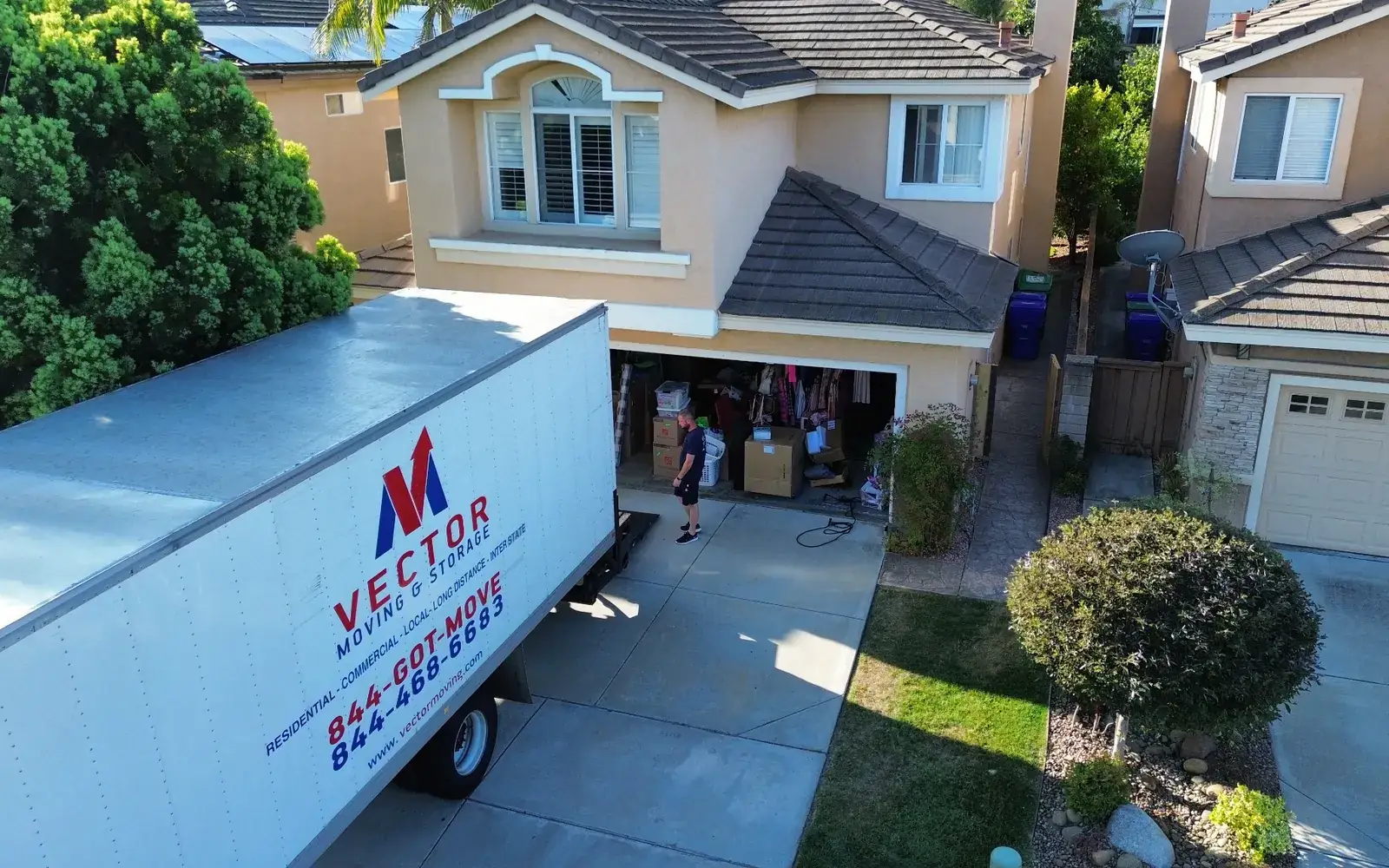 Real Vector moving truck positioned at a San Diego residential driveway