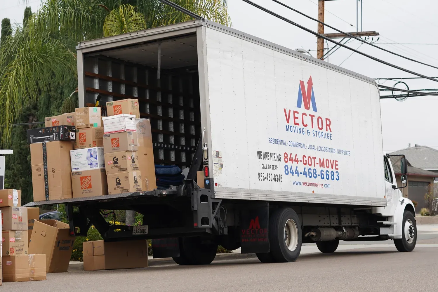 Vector moving truck loaded with labeled boxes during a household move
