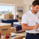 Illustration of a Vector mover reviewing a moving inventory beside labeled boxes